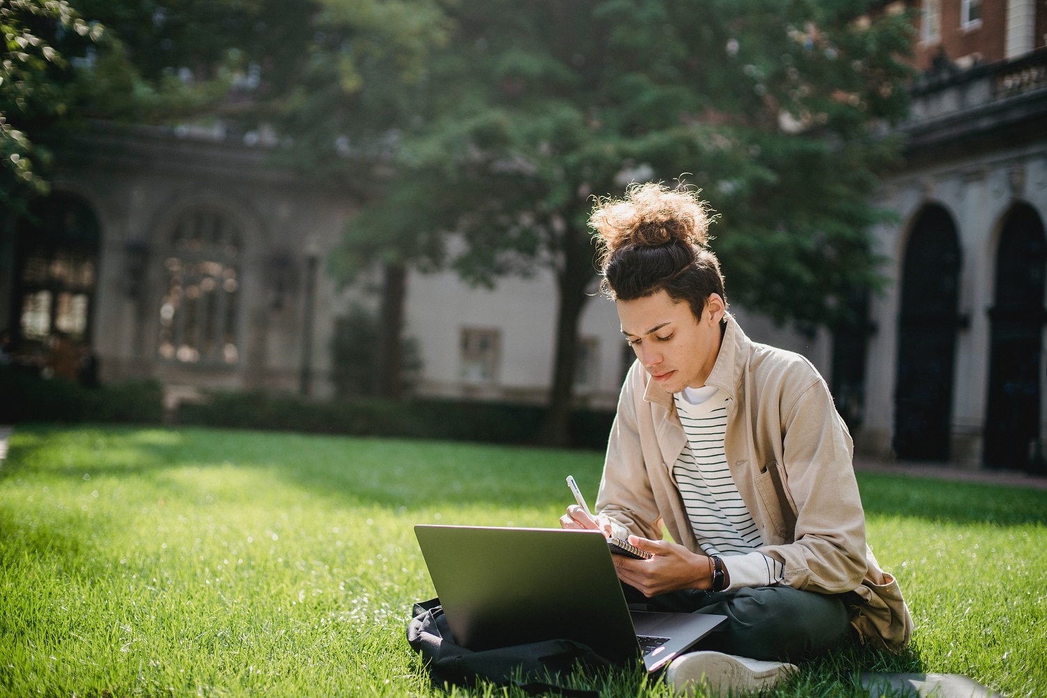 how to subtract in excel person sitting on the grass taking notes at a laptop