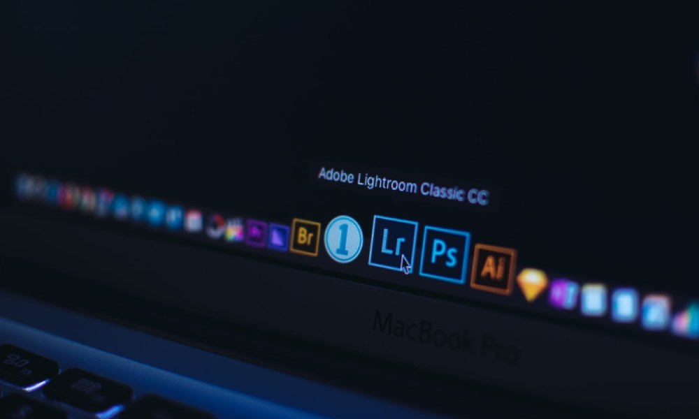 A MacBook Pro displaying the Adobe Lightroom icon.