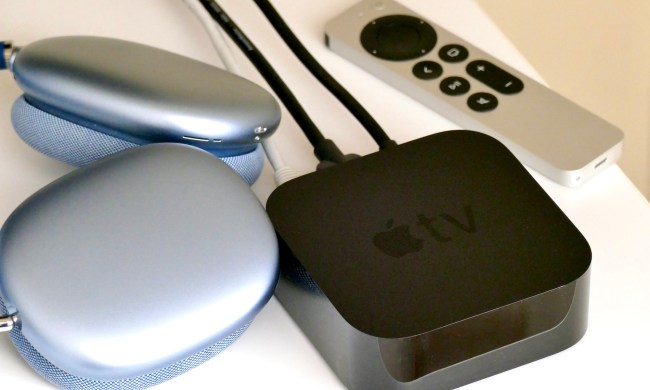 The AirPods Max and Apple TV 4K with remote on a table.