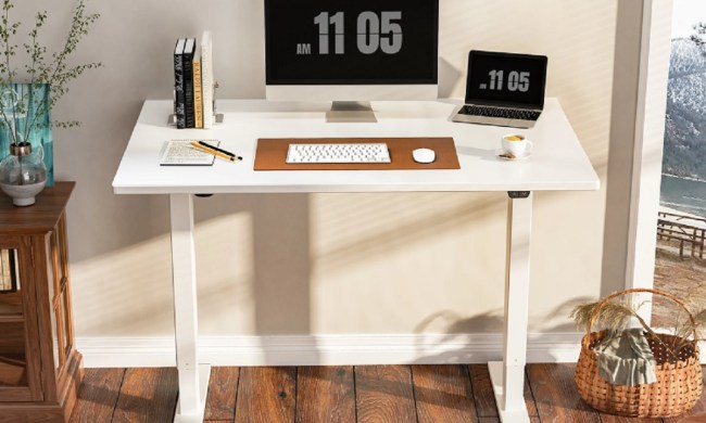 The Inbox Zero Dojtcho Height Adjustable Standing Desk with an all-in-one computer and laptop on top.