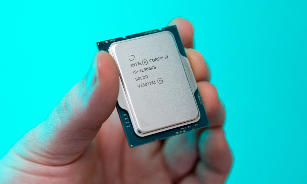 A hand holds the Intel Core i9-12900KS.