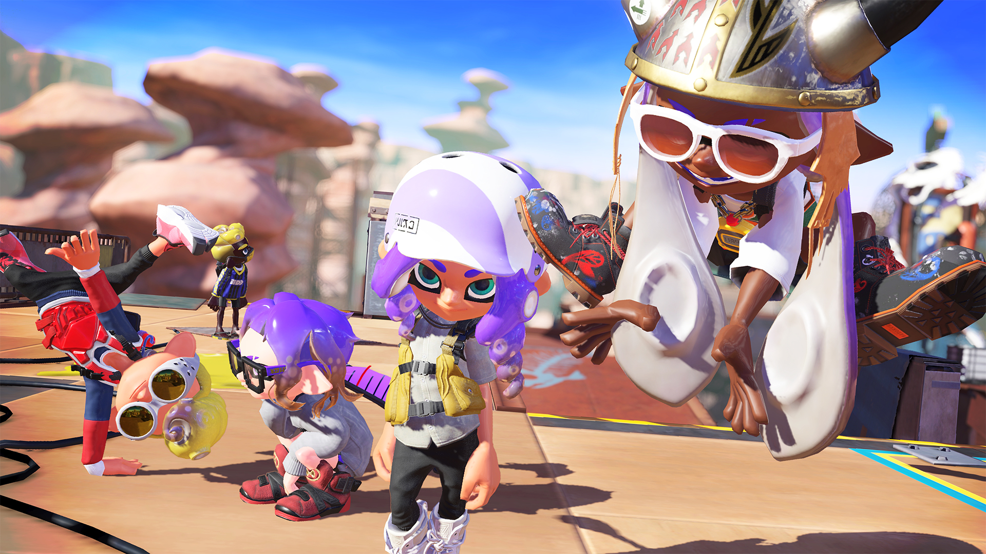 Quatre inklings de Splatoon 3 debout ensemble.