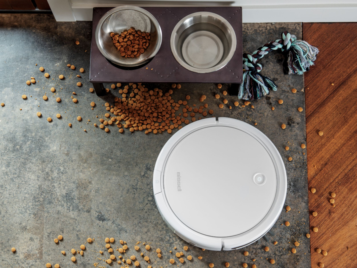 BISSELL SpinWave wet and dry robotic vacuum cleaning spilled dog food.