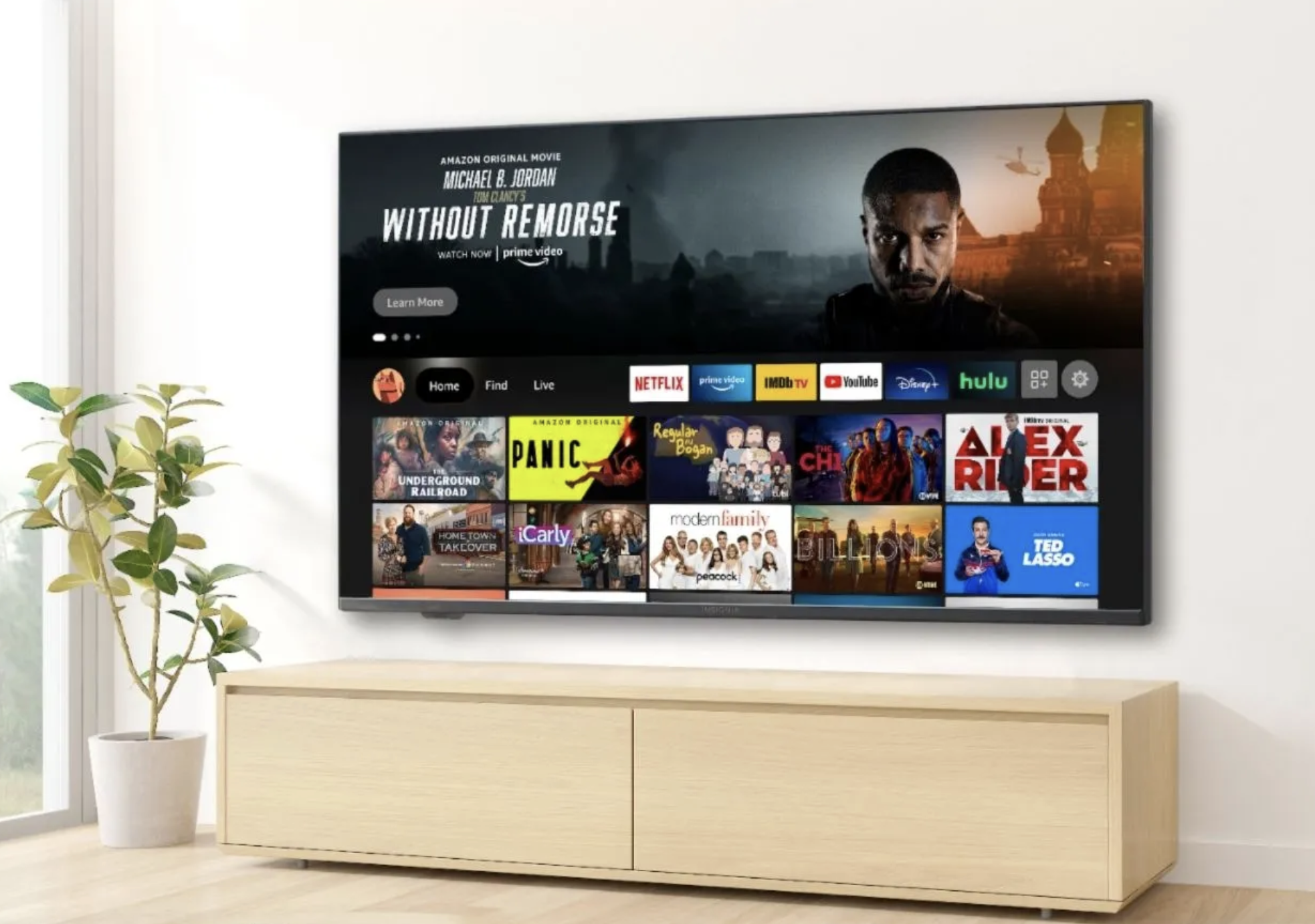 A TV 4K da série Insignia F30 montada em uma parede com a interface Fire TV na tela.