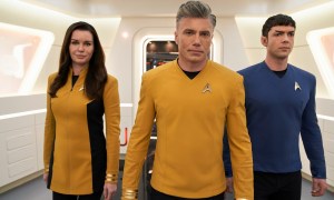 Rebecca Romijn, Anson Mount, and Ethan Peck walk in the hallway of the USS Enterprise in a scene from Star Trek: Strange New Worlds.