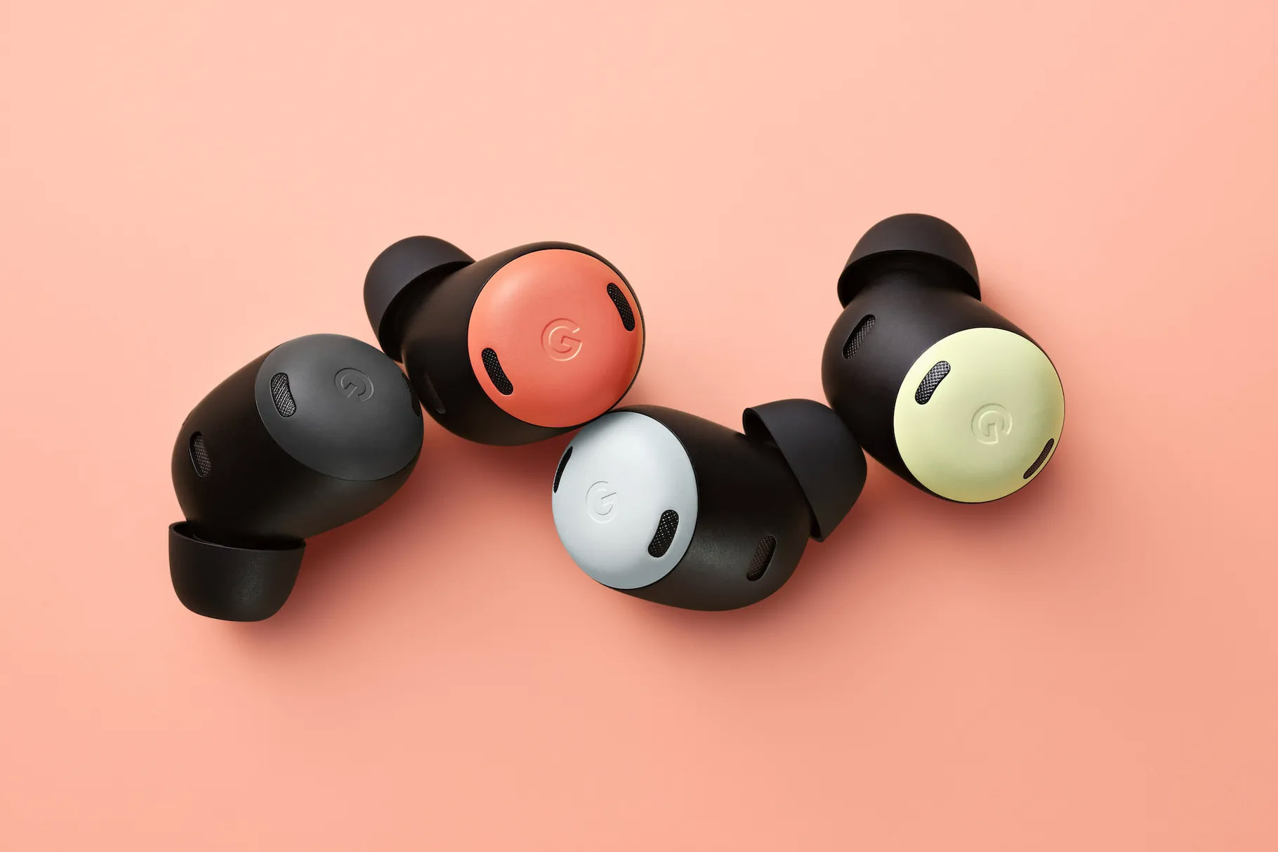 Four individual Pixel Buds Pro headphones sit on a pink background.