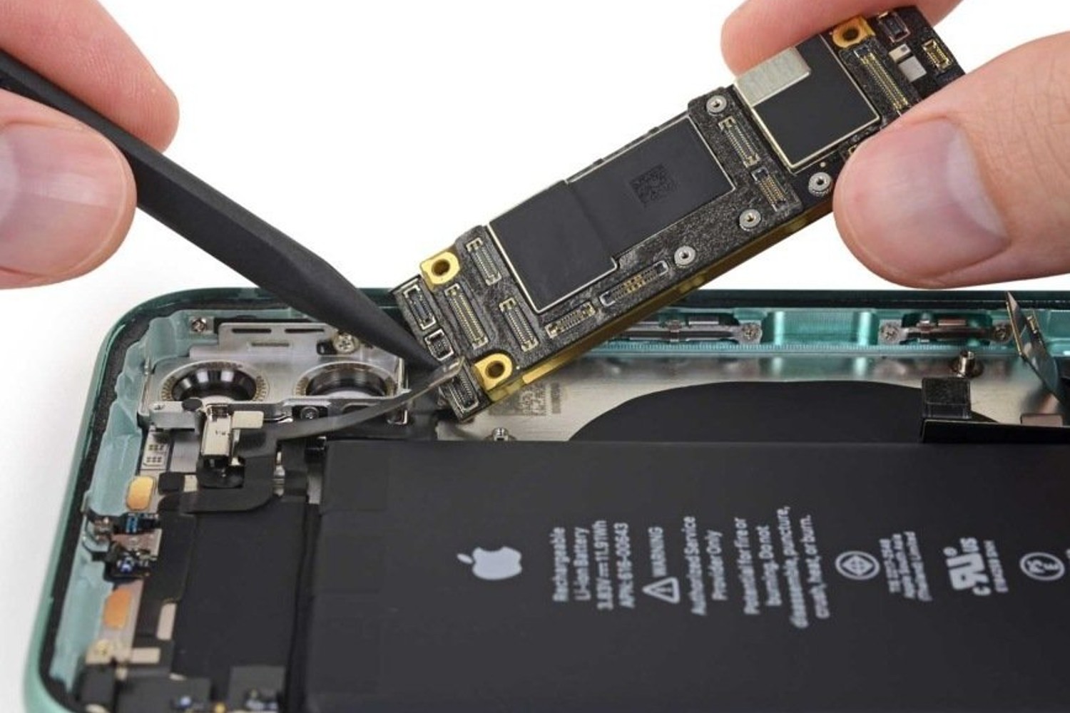 Someone repairing an iPhone with an iFixit kit