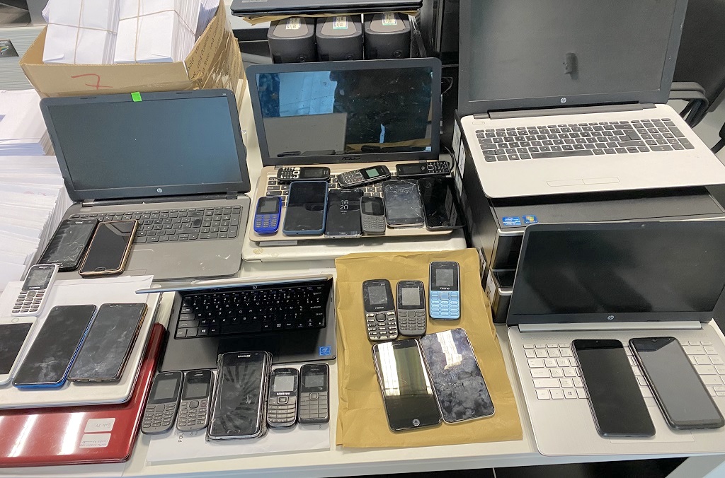 Phones and other digital devices seized during Interpol's investigation into social engineering scams.