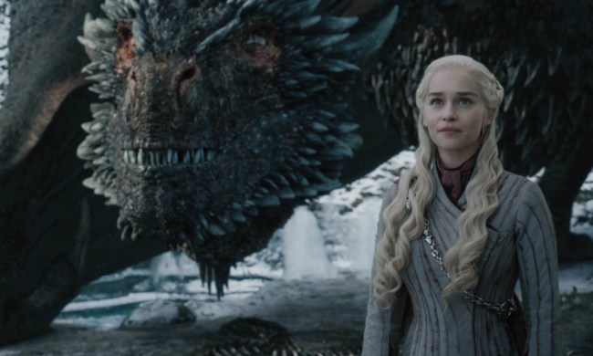 Daenerys Targaryen with Drogon behind her in Game of Thrones.