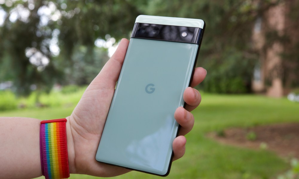 Someone outside holding the Pixel 6a. We see the back of the phone.