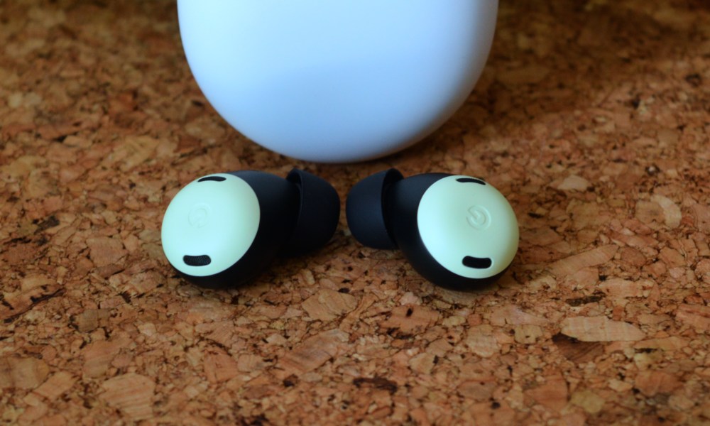 Google Pixel Buds Pro seen in front of their charging case.