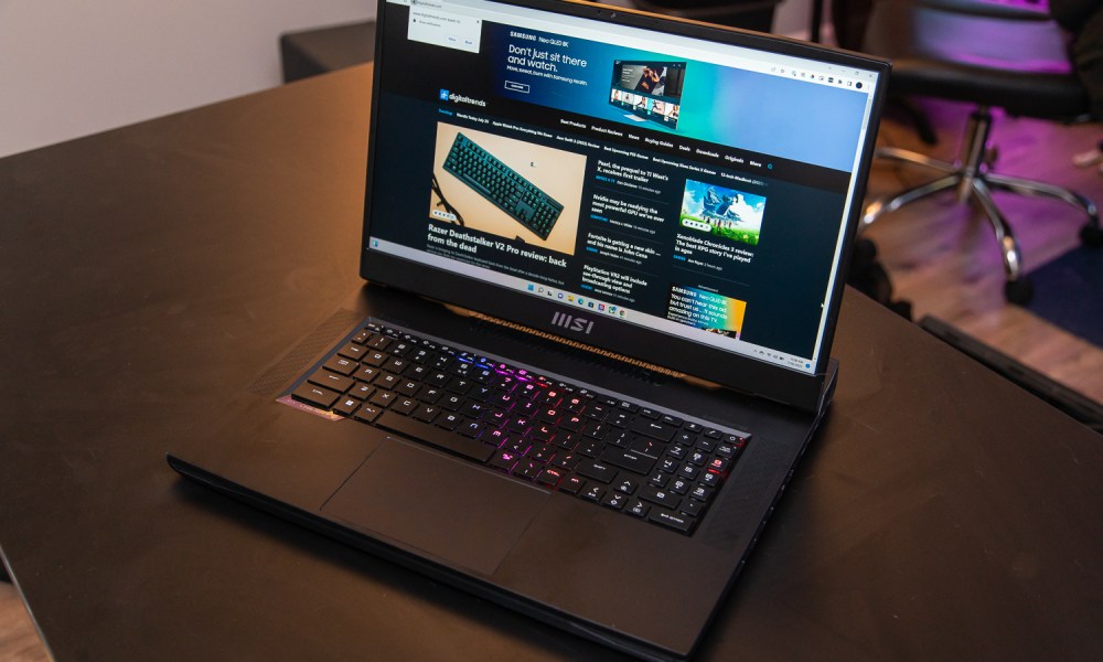 MSI GT77 Titan with the Digital Trends website up sitting on a table.