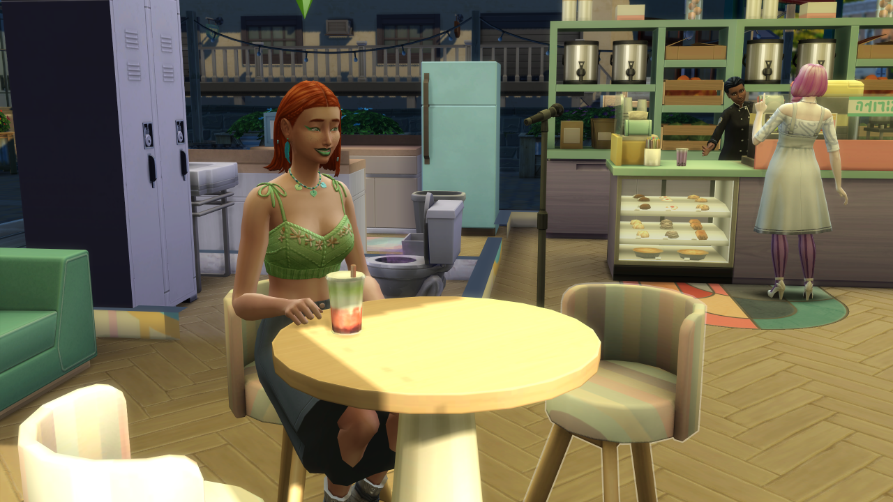 Ein Sim sitzt mit einem Boba-Tee in Die Sims 4: High School Years an einem Tisch.