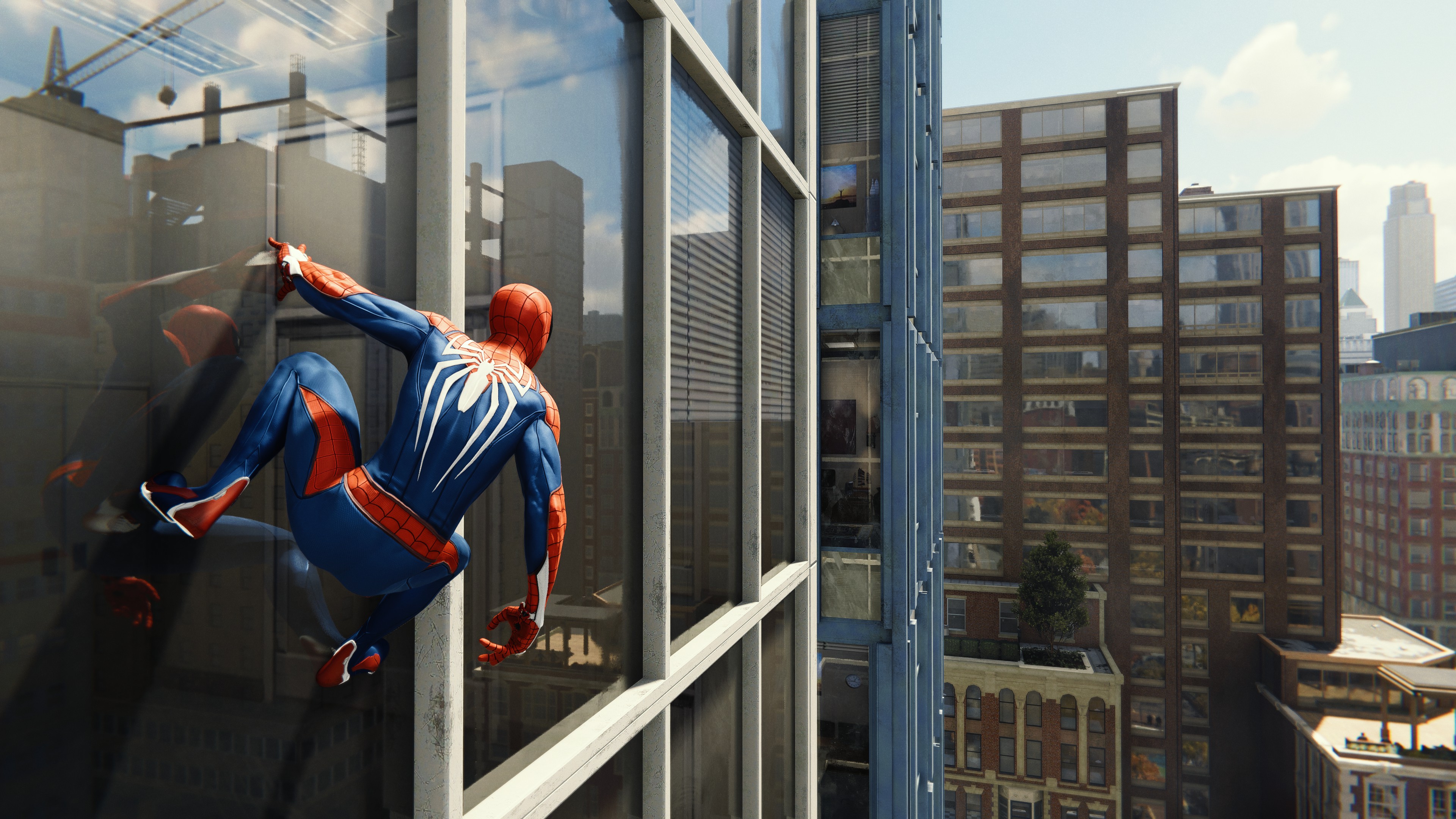 Peter Parker hanging on a building in Marvel's Spider-Man.