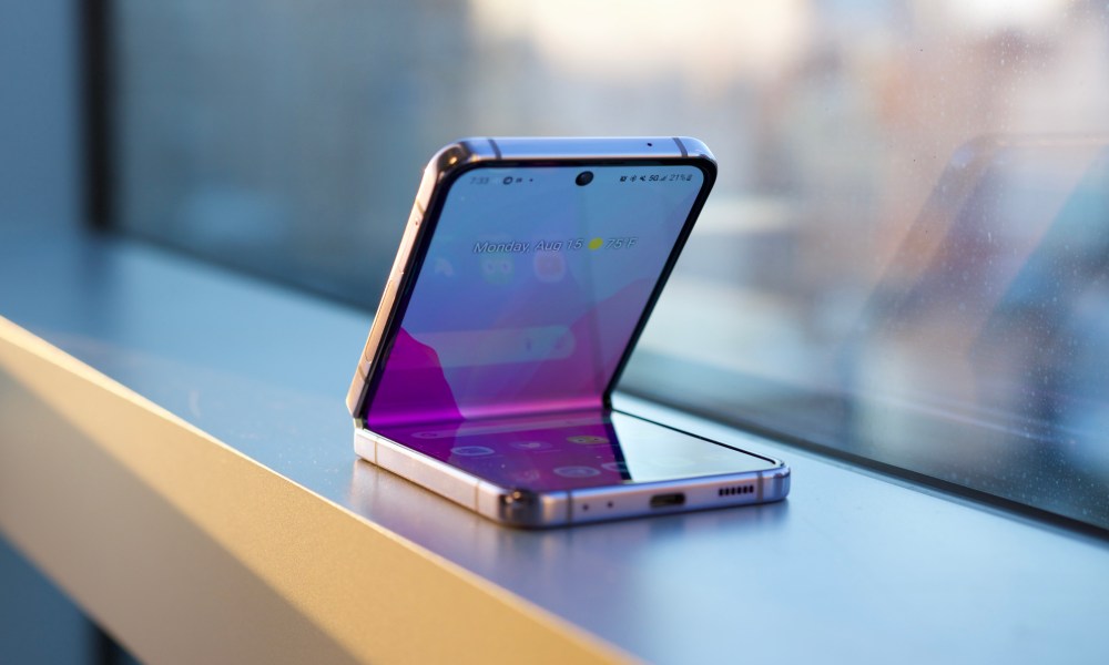 The Samsung Galaxy Z Flip 4 sitting on a window ledge.