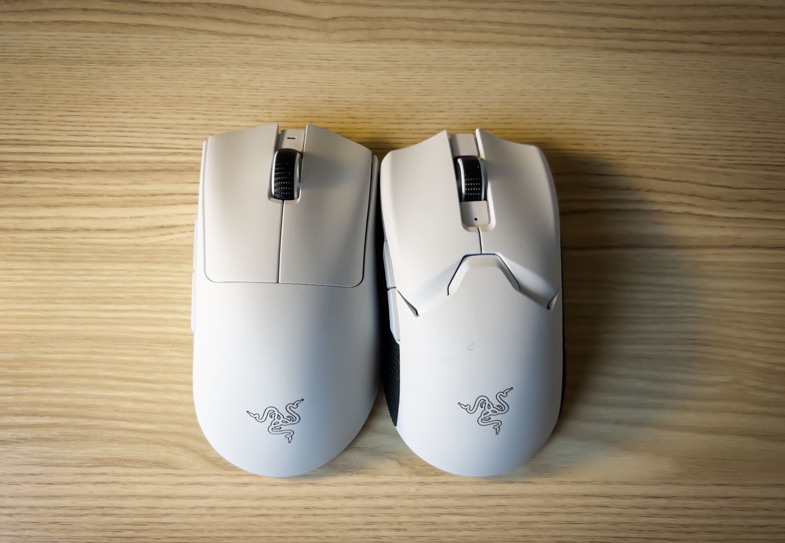 The Razer viper and DeathAdder on a wooden desk.