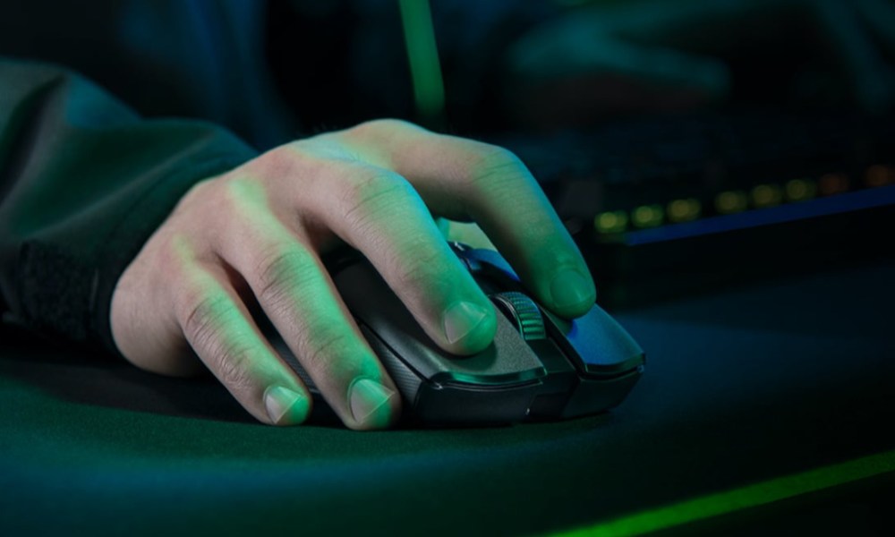 The Razer Viper Ultimate gaming mouse with a hand on top.