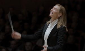 Cate Blanchett conducts music while wearing a suit in TÁR.