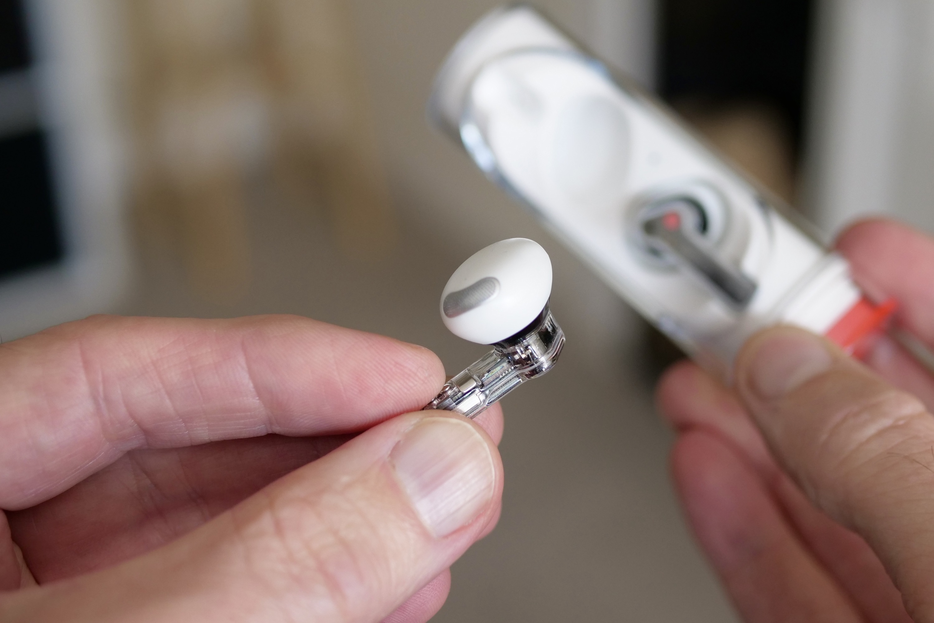 The Nothing Ear Stick's earbud, held between a person's finger.