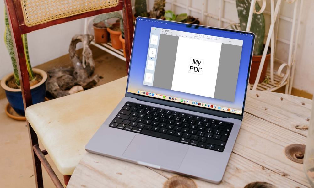 MacBook on a table with a PDF in Preview.