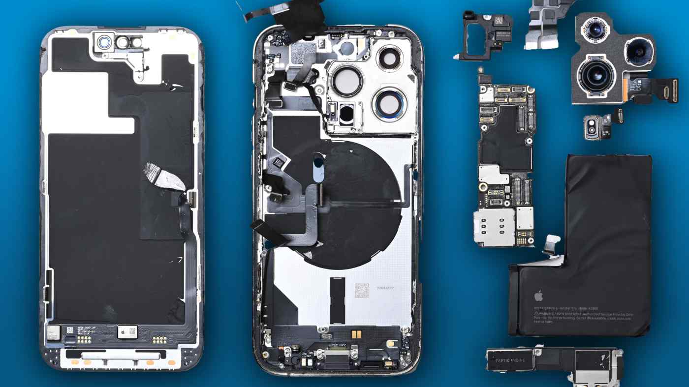 An iPhone 14 pulled apart, revealing all of the components inside.