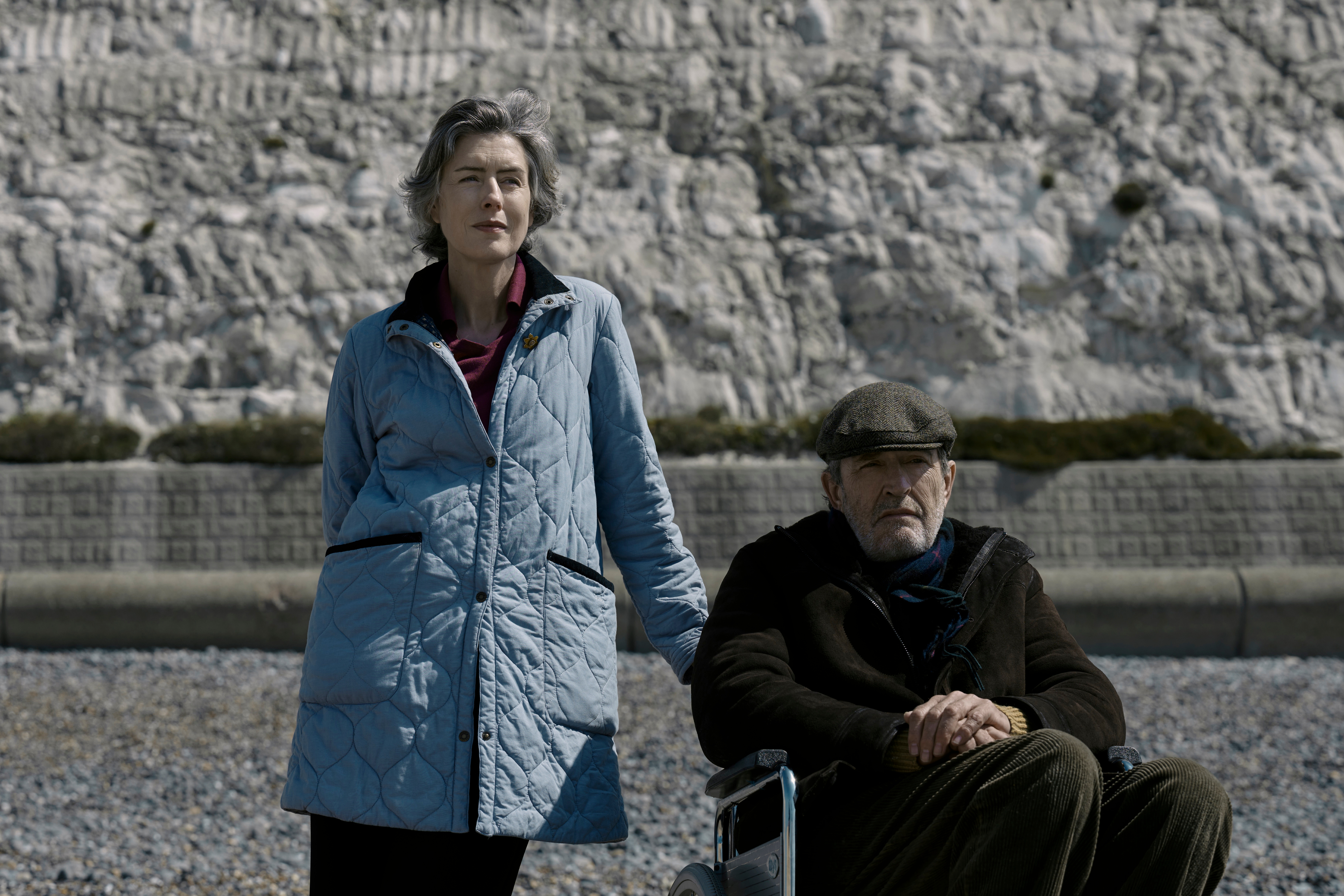 Gina McKee stands on a beach next to Rupert Everett in My Policeman.