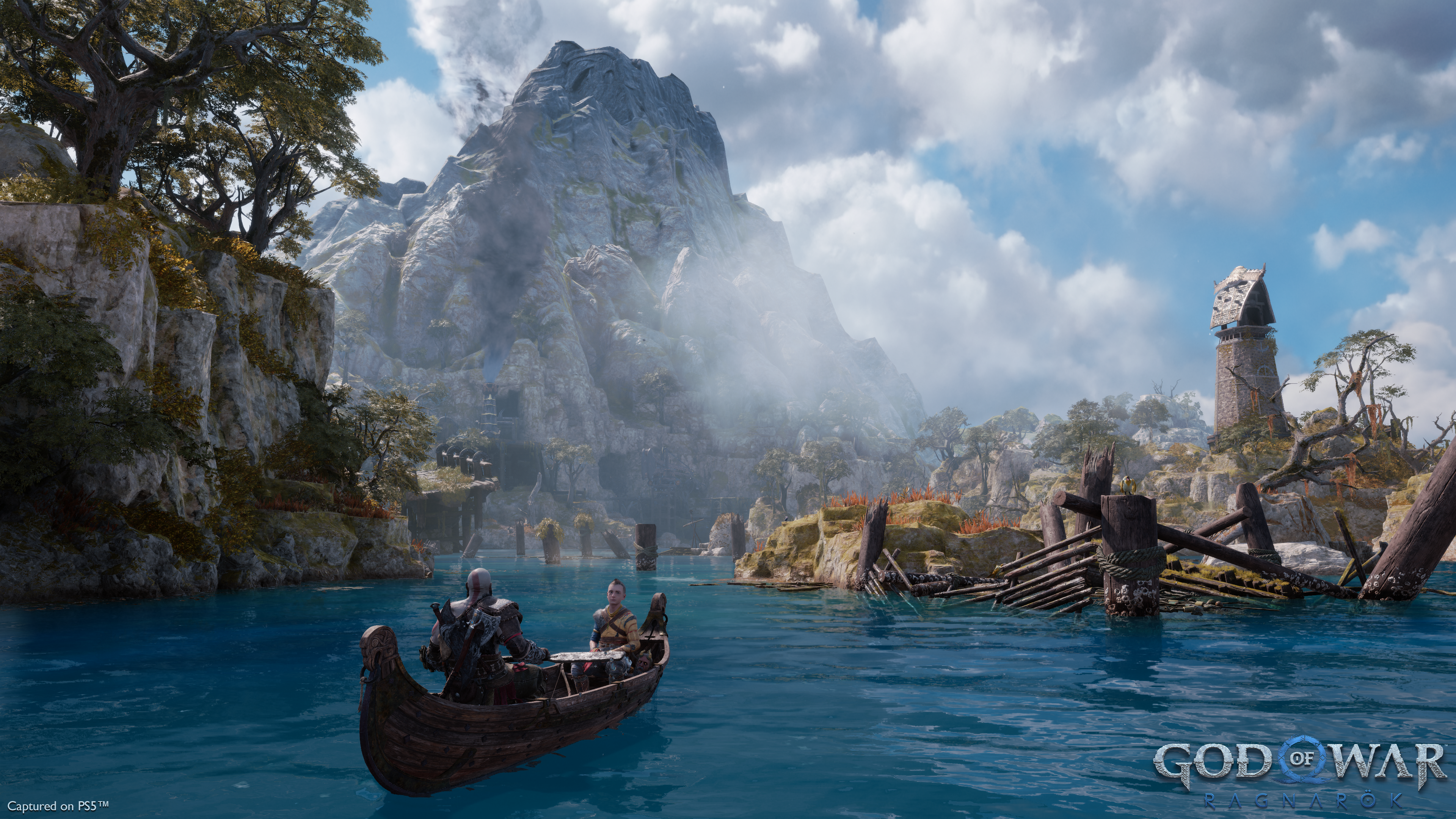 Kratos and Atreus travel by boat in God of War Ragnarok.