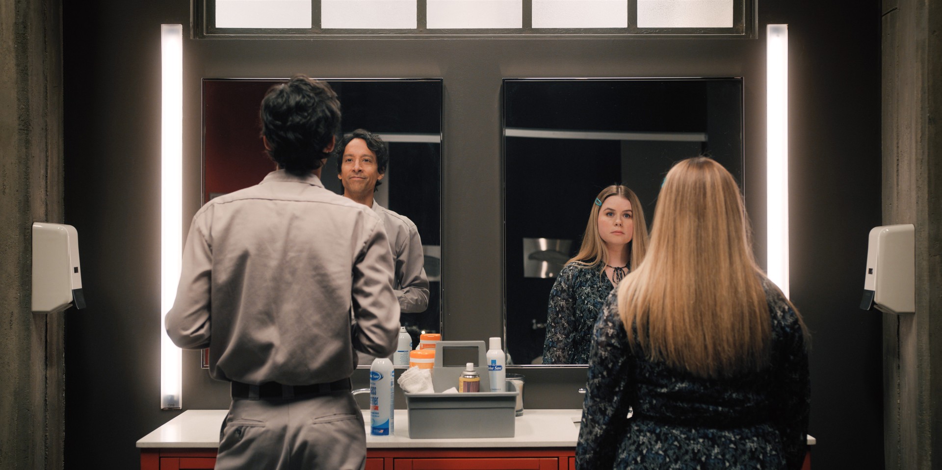 Danny Pudi and Jessie Ennis stare into mirrors in a scene from season 3 of Mythic Quest.