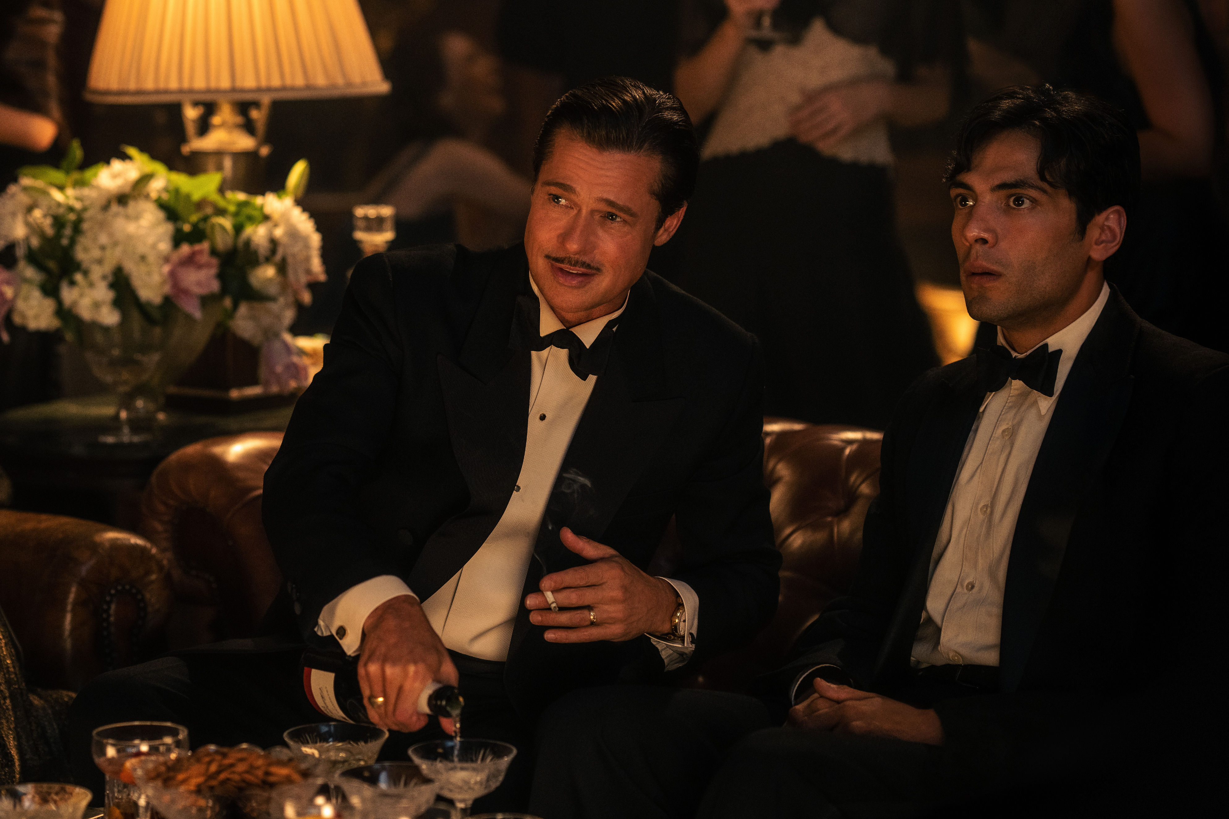 Brad Pitt sitzt mit Diego Calva in Babylon.