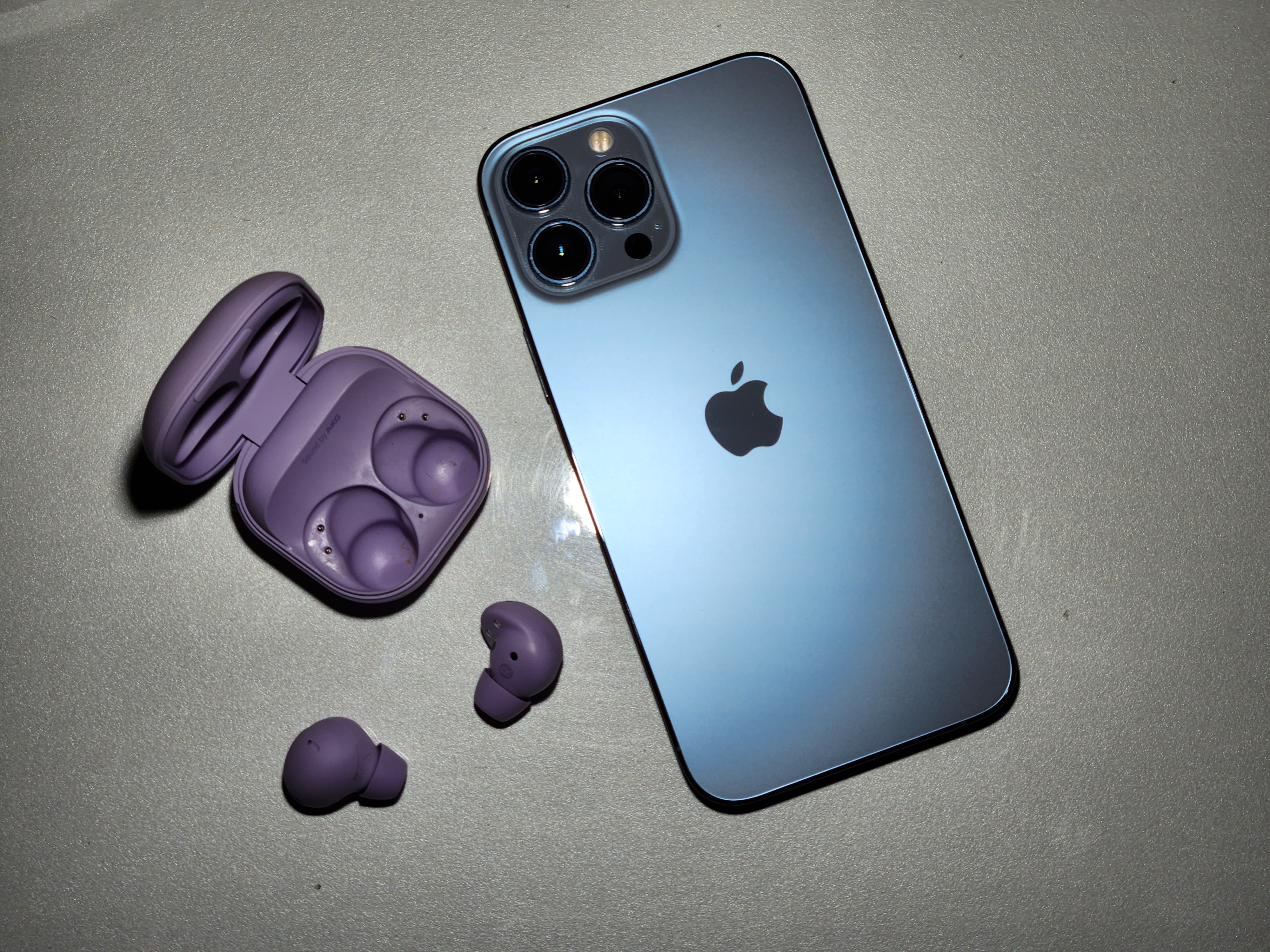 Galaxy Buds 2 Pro with iPhone 13 Pro Max on a table