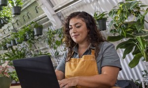 A business owner using QuickBooks Online on a laptop.