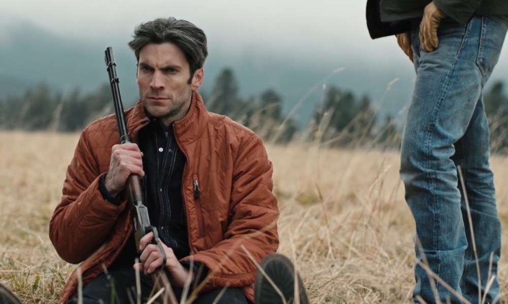 Jamie Dutton holding a gun in Yellowstone.