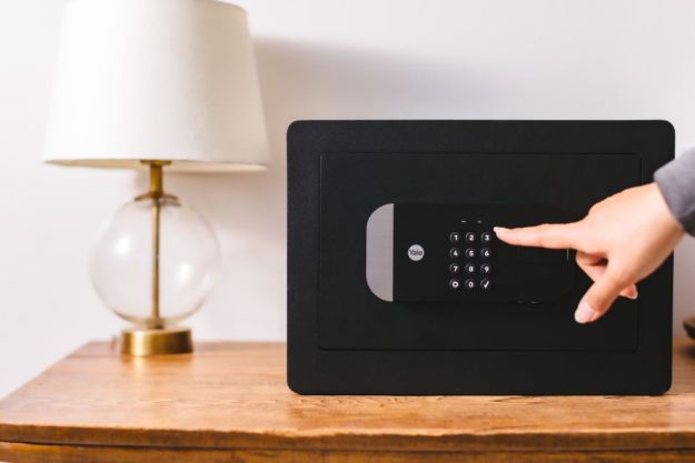 A person pointing to the Yale Smart Safe.