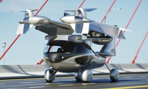 The Aska A5 flying car drives across a bridge with its rotor arms folded up for storage.