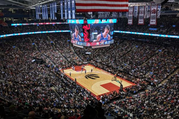 Toronto Raptors stadium with seats packed and fans cheering.