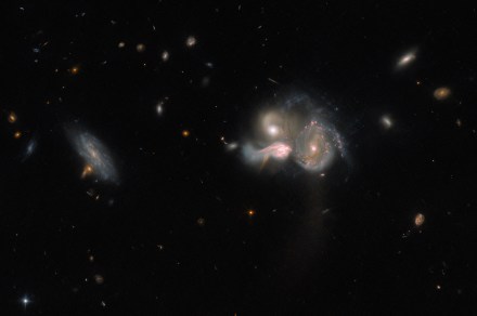 Three galaxies are in the process of merging in this Hubble image