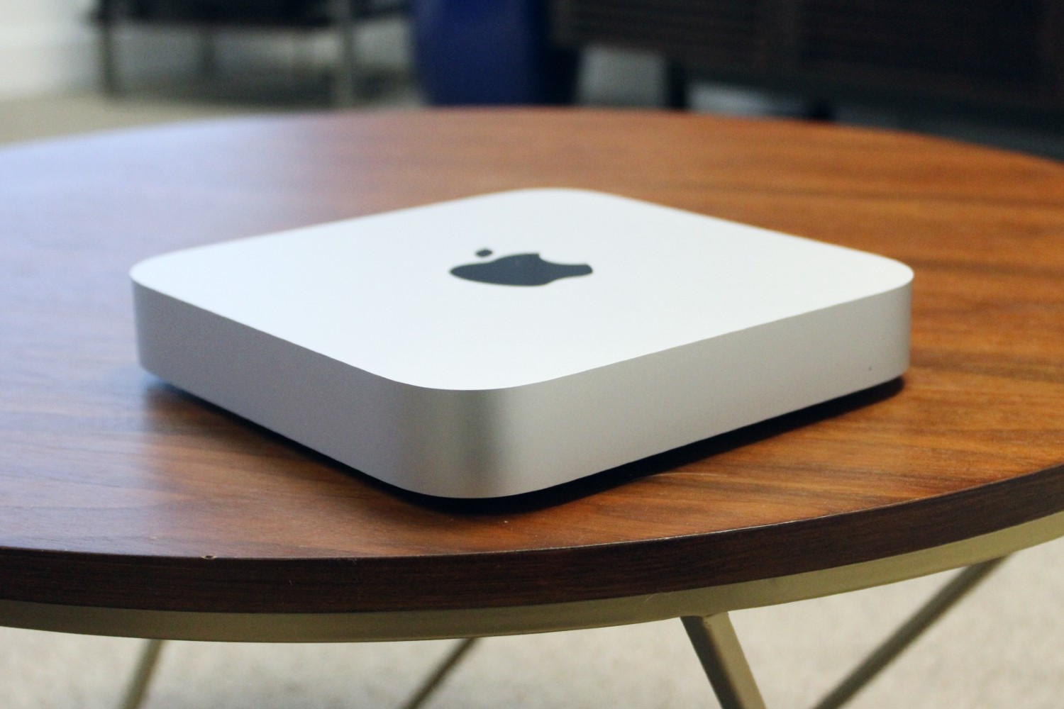 The Mac mini on a wooden desk.