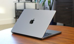 The MacBook Pro on a wooden table.