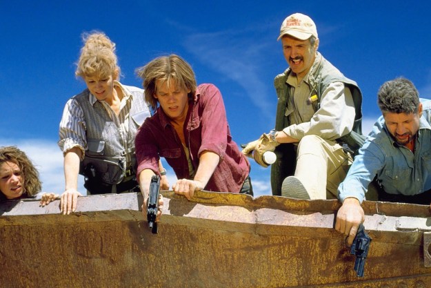 A group of point people point guns at the earth in Tremors.