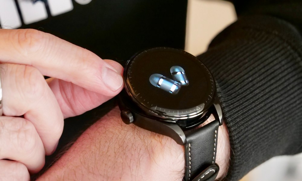 Opening the Huawei Watch Buds's top.