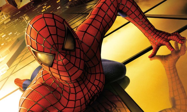 Spider-Man crawling on the side of a skyscraper in a poster for "Spider-Man" (2002).