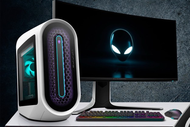 An Alienware Aurora R15 gaming desktop alongside a gaming monitor on a desk.