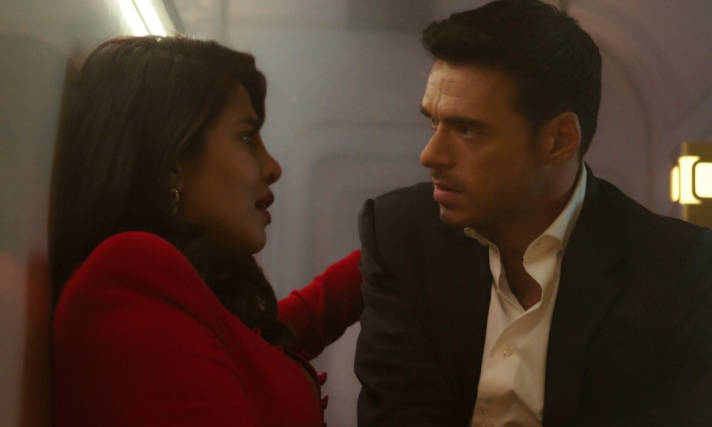 Richard Madden and Priyanka Chopra Jonas look at each other on a train in Citadel.