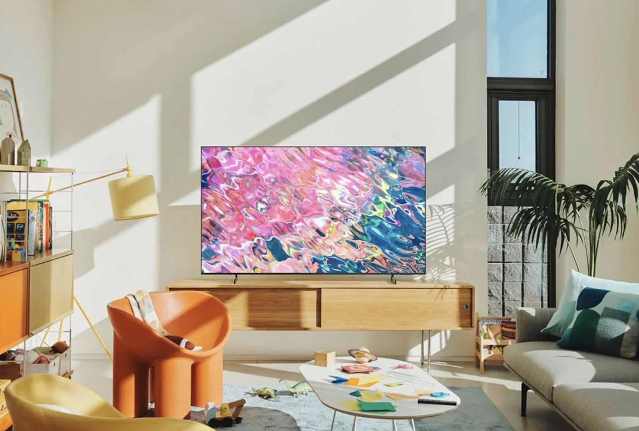 A Samsung Q60B QLED Smart TV sits on the media cabinet in the living room.