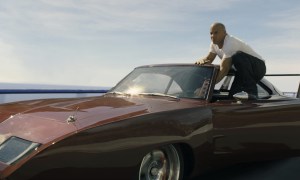 Vin Diesel stands on his car in Fast & Furious 6.