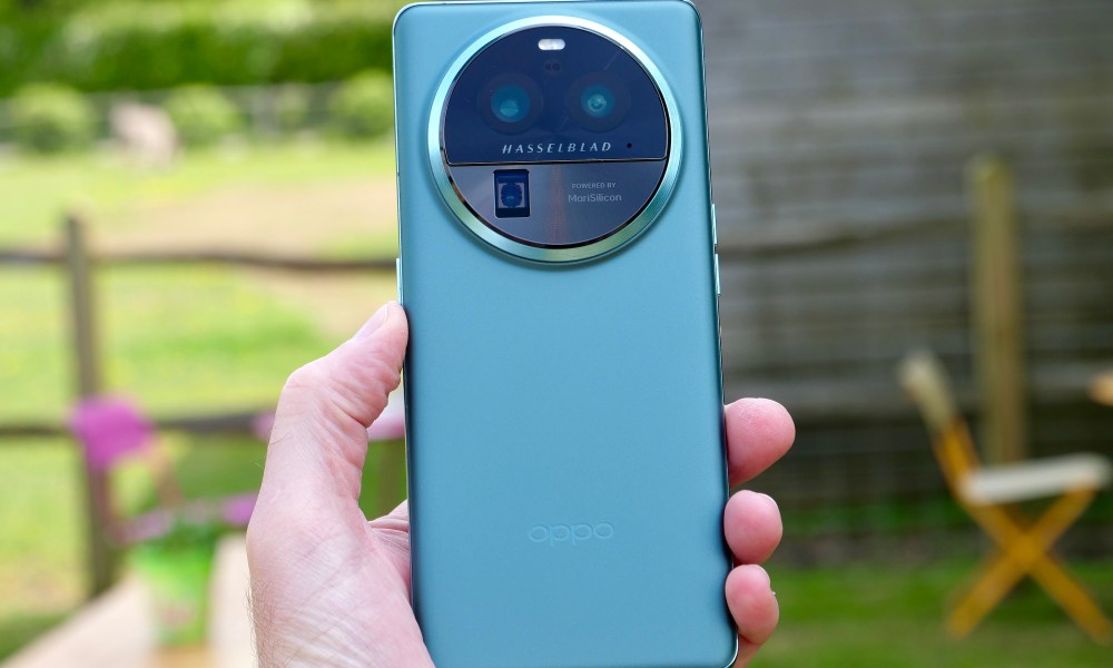 A personification holding nan Oppo Find X6 Pro, showing nan backmost of nan phone.