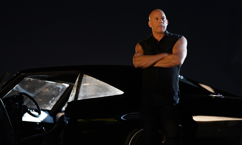 Vin Diesel leans against a car in Fast X.