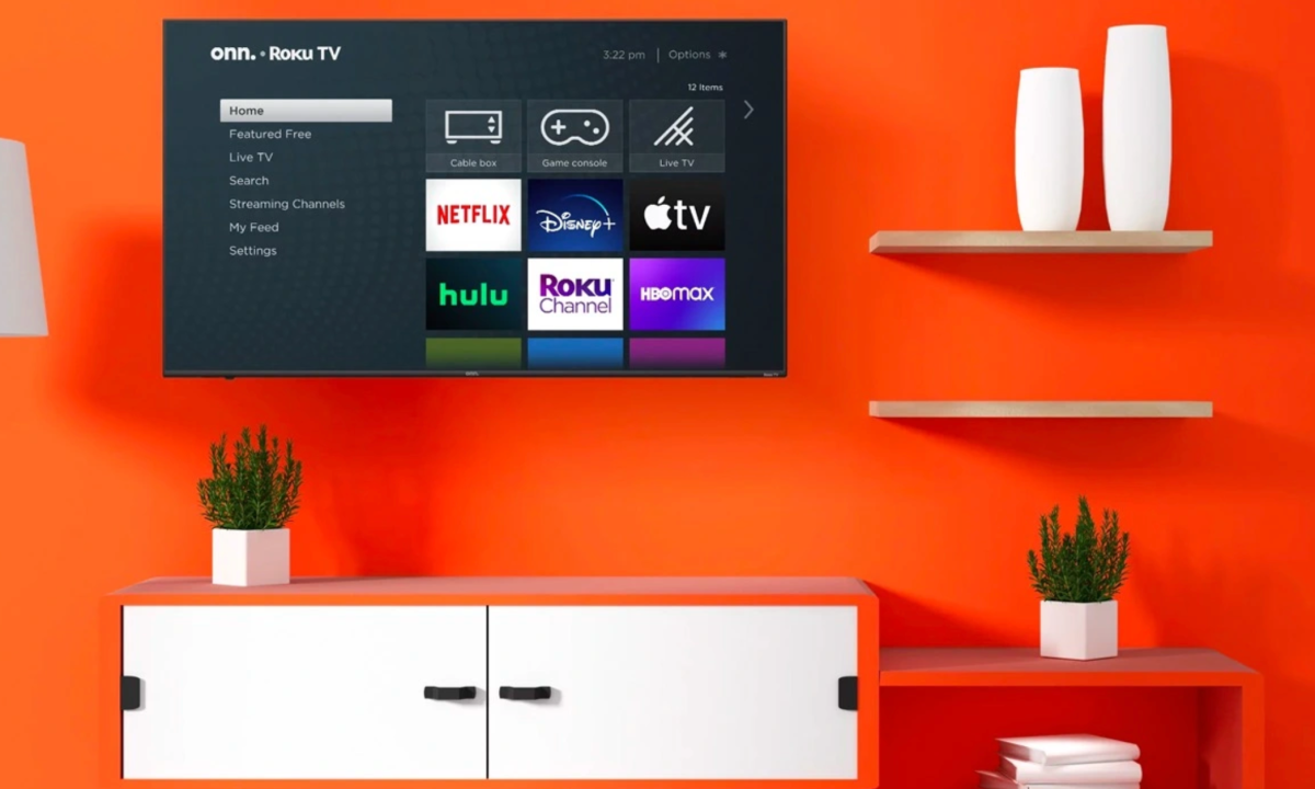 The onn. 70-inch 4K Roku TV hangs on the wall as part of a home theater arrangement.