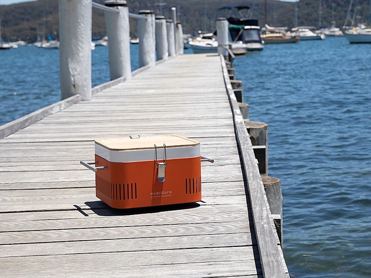 The Everdure CURE portable grill on a dock.