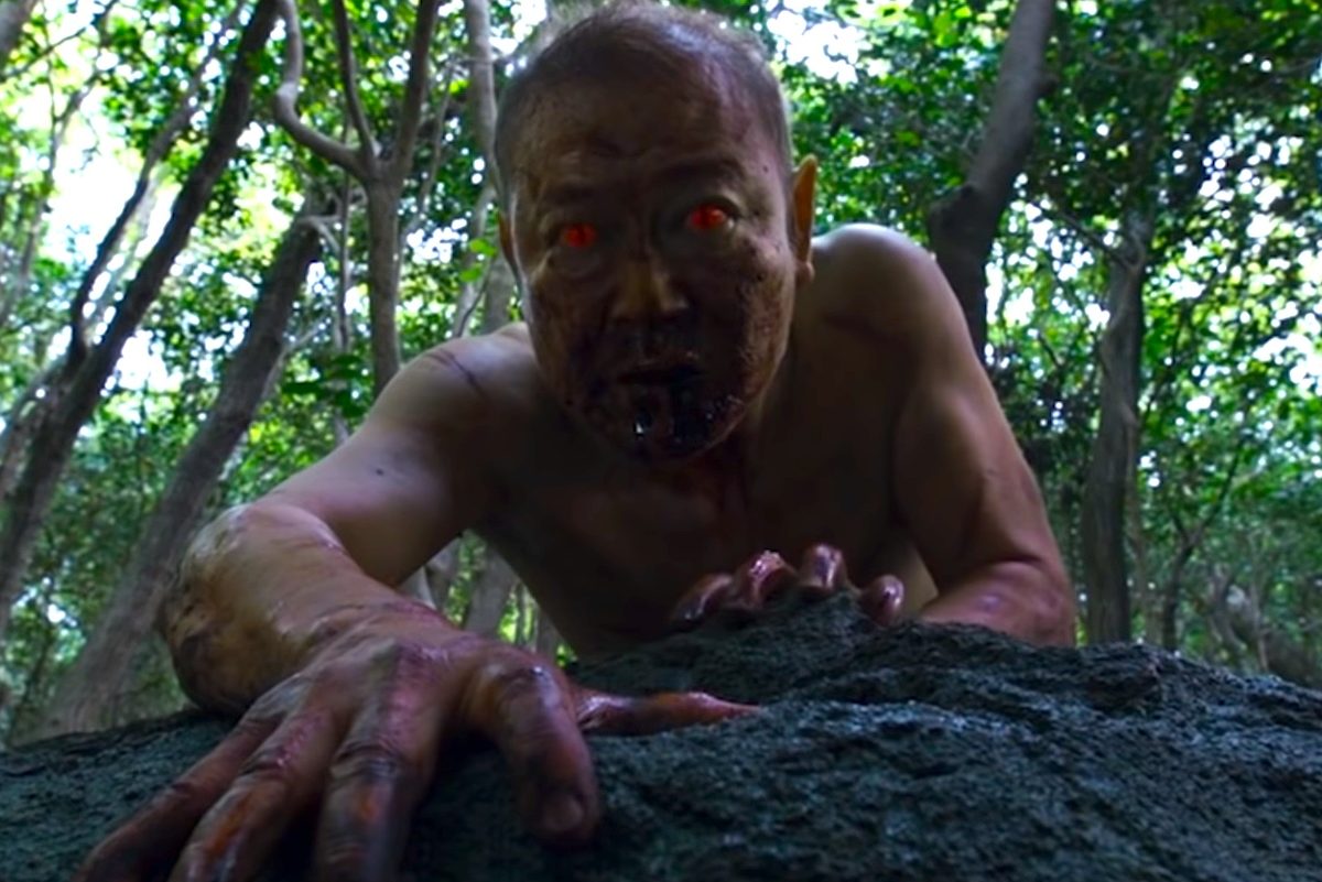 A man with demonic red eyes in "The Wailing."